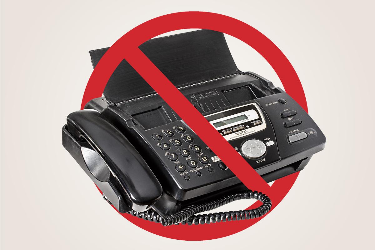 A fax machine with a NO red symbol around it. 